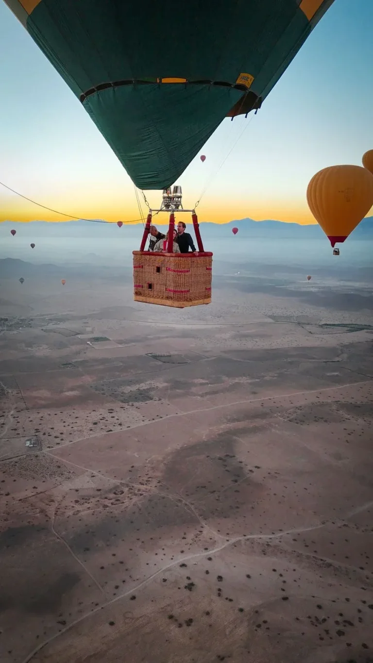 Hot air balloon basket floating above the desert plain near Marrakech