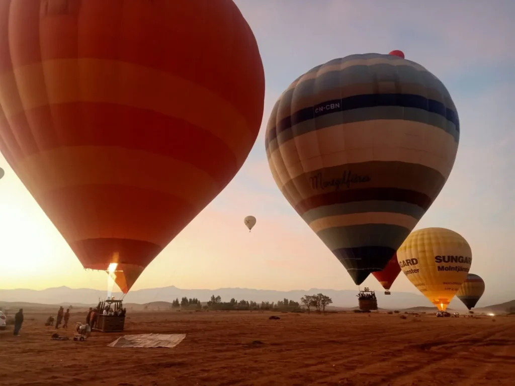 Hot air balloons being inflated at sunrise on the plain outside Marrakech